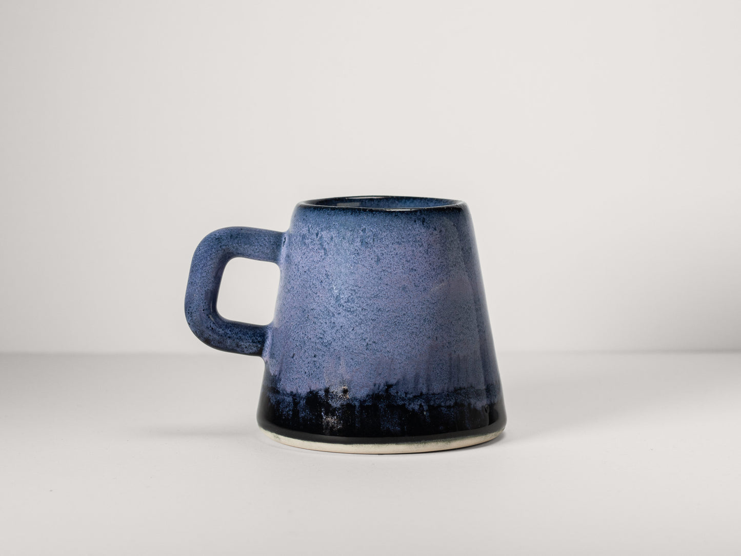 Blue ceramic mug on a light gray background