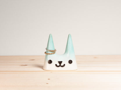 Ceramic cat-shaped ring holder on a wooden surface