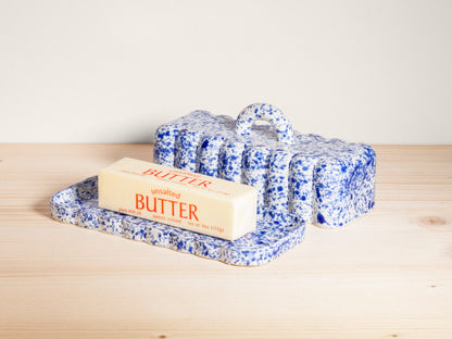 Butter bar on a blue speckled tray with a white background