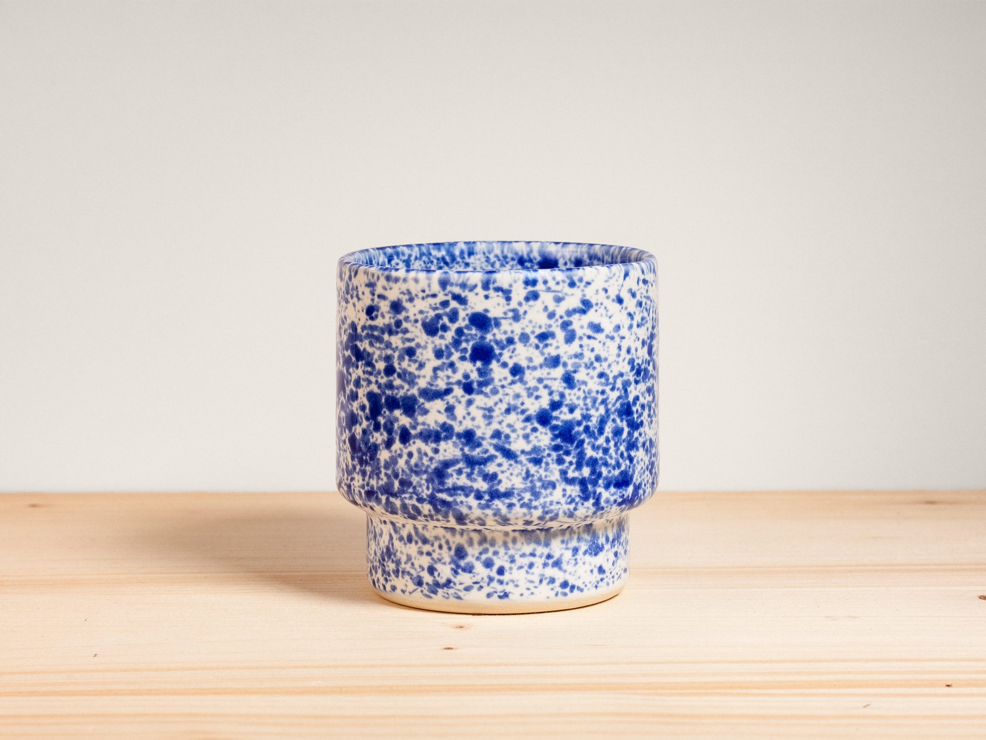 Blue and white ceramic cup on wooden surface