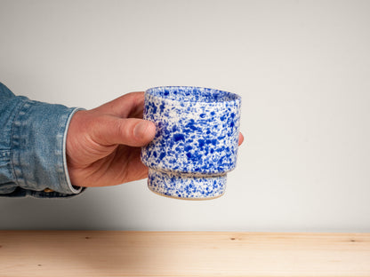 Blue and white ceramic cup on wooden surface