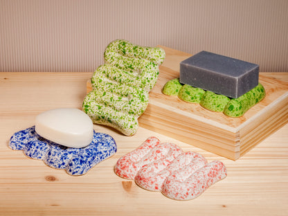 Ceramic soap dishes on wooden surface